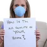 Woman wearing respirator at home.