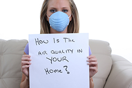 Woman wearing respirator at home.